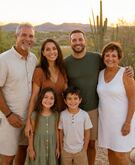A family smiling together outdoors